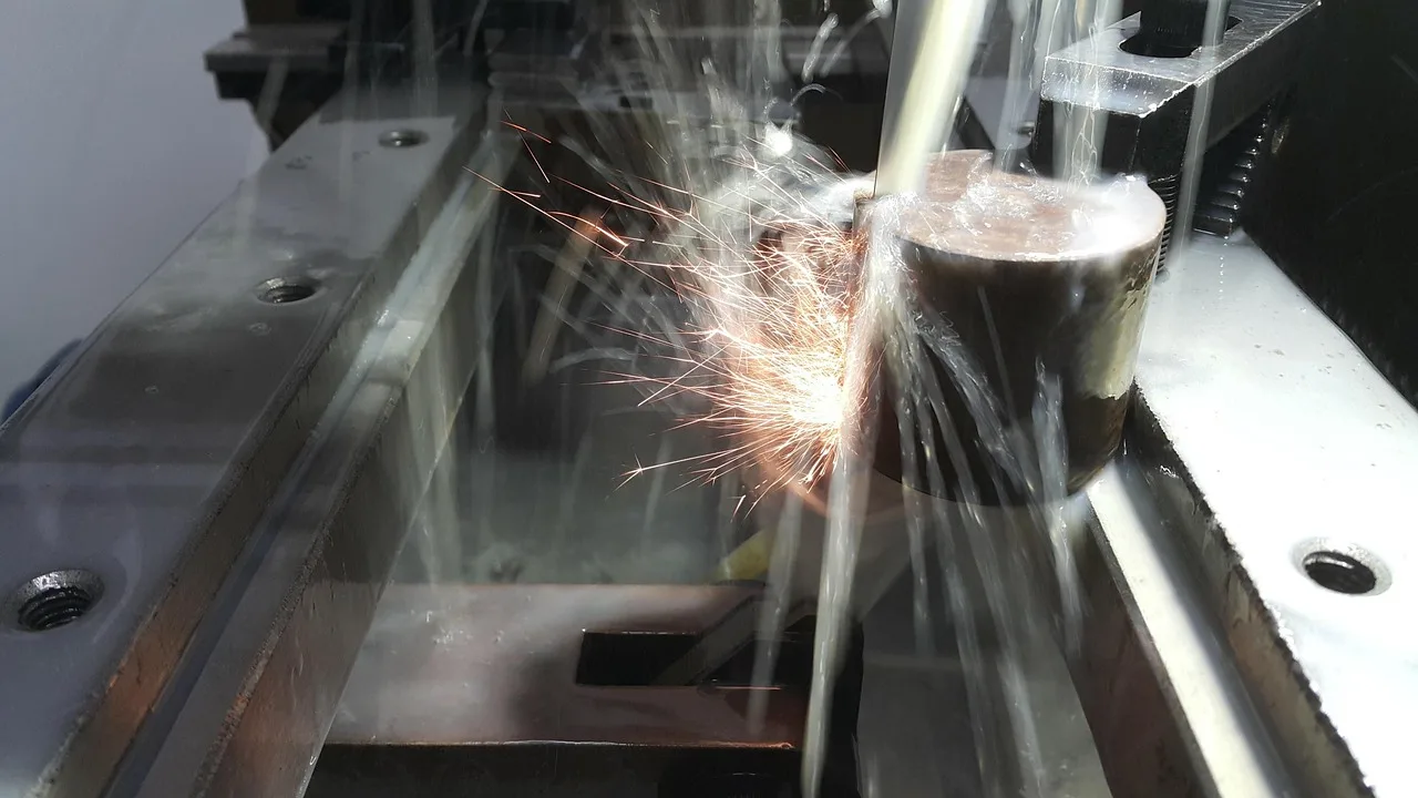 Wire EDM machining process creating precision slots on a metal part